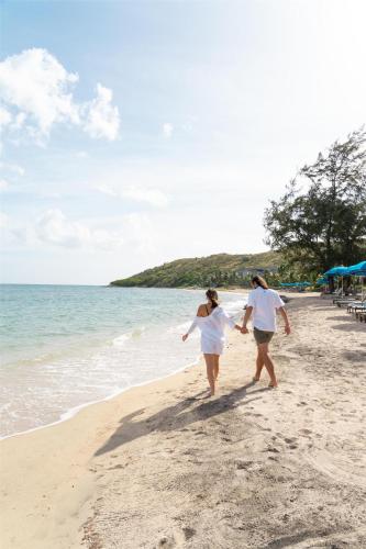 two women walking on the beach at Park Hyatt St. Kitts in Christophe Harbour
