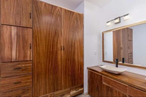 a bathroom with a wooden sink and a mirror at Spacious and luxurious Yumil Condominium 137m2 in Los Barriles