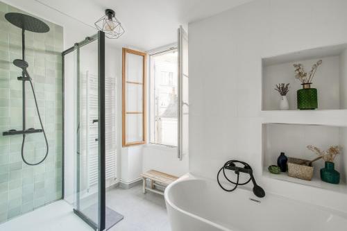 une salle de bain blanche avec une baignoire et une douche dans l'établissement Maison Jardin - Centre Angers, à Angers