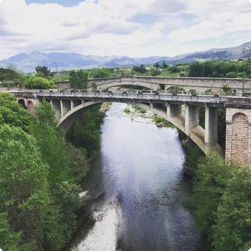 a bridge over a river next to a river at Studio des fleurs in Céret