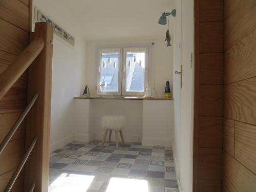 - un couloir avec une fenêtre et une chaise dans la chambre dans l'établissement Ti gwenn 6p-Maison 3ch-Terrasse Port Maria Wifi, à Quiberon
