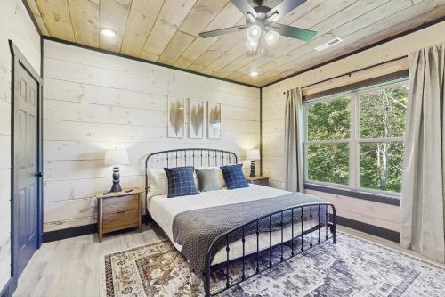 a bedroom with a bed and a ceiling fan at Getaway Pointe in Sevierville
