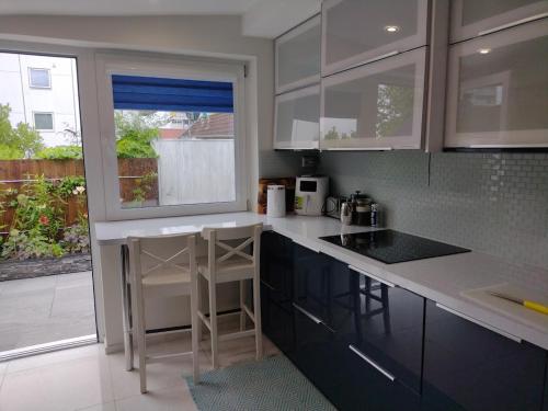 a kitchen with black and white counters and a window at Villa Baneheia-Studios & Apartment in Kristiansand