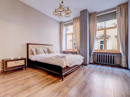 a bedroom with a bed and a large window at Old Riga 1BR, Doma Square Views in Rīga
