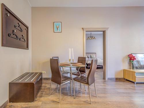 a dining room with a table and chairs at Old Riga 1BR, Doma Square Views in Rīga
