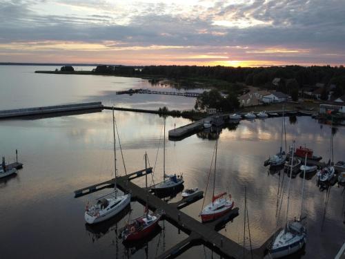 a group of boats docked in a marina at sunset at holiday home in Stepnica for 6 persons in Stepnica