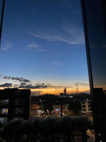 a view from a window of a city at sunset at Blessing House in Bogotá