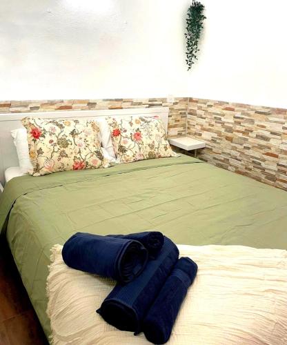 a bed with two blue pillows on top of it at Apartamento Mar del norte, en Cotillo. in El Cotillo