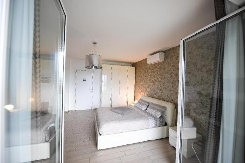 a small bedroom with a bed and a shower at Karol Wojtyla Airport Bari in Bari