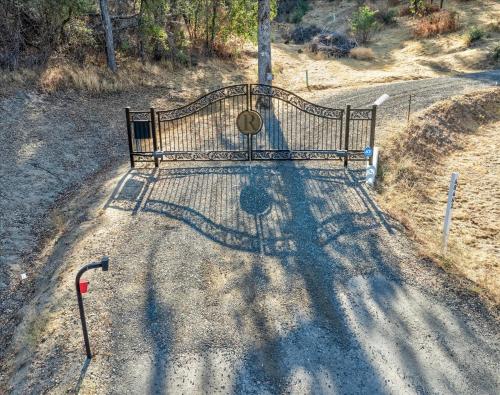 a park bench sitting on the side of a road at Hilltop Paradise with stunning views/hot tub/firepit/dog friendly in Oakhurst