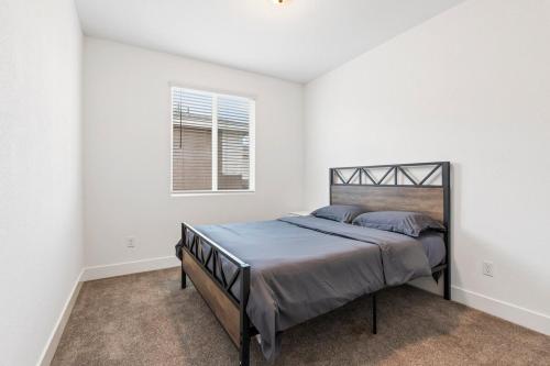 a bedroom with a bed in a white room at Perfect Brand New Home in Merced in Merced