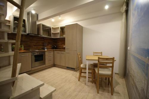 a kitchen with a table and chairs in a room at Old town apartaments in Kaunas