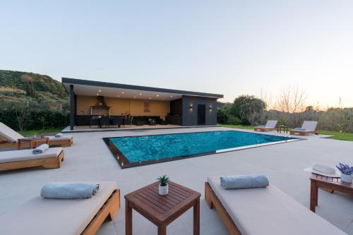 a swimming pool in the backyard of a house at Luxury private villa queen Alla in Dragotiná