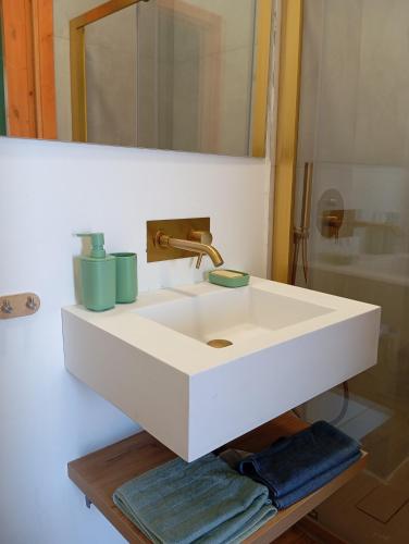 a bathroom with a white sink and a mirror at "Meine Sonne - Essenza di Riviera Holiday Home" con vista mare, terrazzo e parcheggio in Imperia