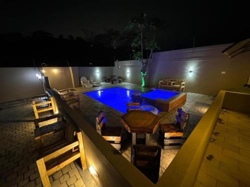 a swimming pool at night with a table and chairs at Durban Holiday Apartments by Mieli Estates , Unit 6 in Durban