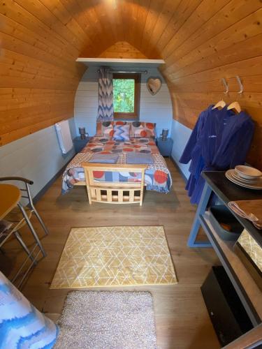a room with two beds and a table in a cabin at Smart glamping site in longtown, with veiws of the Black Mountains in Longtown
