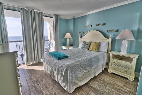 a bedroom with a bed and a balcony with the ocean at Oceanfront Waterpointe 1 Unit 803 3 bedroom 2 bath Balcony Pools in North Myrtle Beach