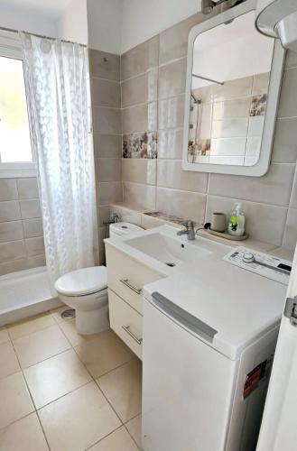 a bathroom with a toilet and a sink and a mirror at Las Americas Blue Ocean Apartment in Costa de Adeje