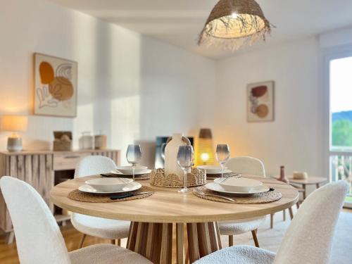 une table en bois avec des chaises et une salle à manger dans l'établissement Suite Namaste - Cozy Apartment, à Épinal