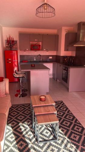 a kitchen with a couch and a table in a room at appartement-Rez de jardin, parking privé et Tram in Bischheim