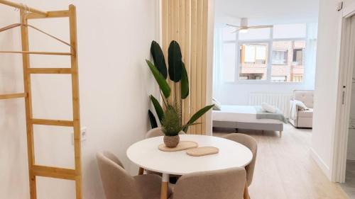 a living room with a table and chairs and a ladder at AT Bilbaotown self check in in Bilbao