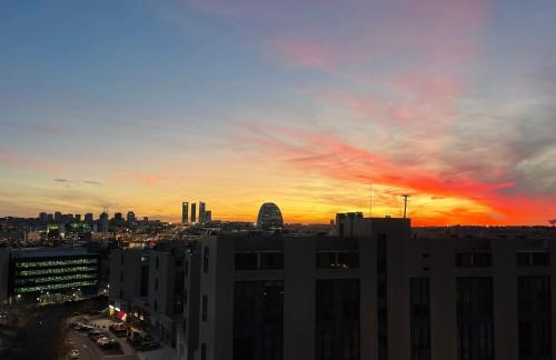 a view of a city skyline at sunset at Lujoso Loft La Moraleja in Madrid