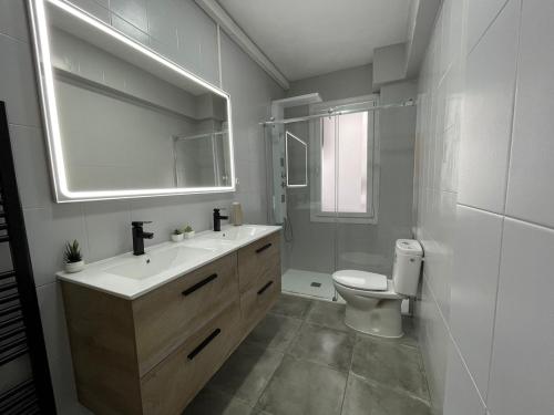 a bathroom with a sink and a toilet and a mirror at El Bierzo - Ponferrada in Ponferrada