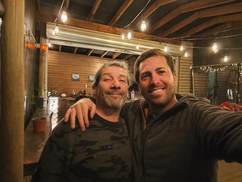 two men standing next to each other in a room at Glamping Puertecillo Surf & Camp in Puertecillo