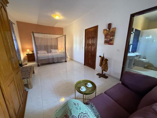 a living room with a couch and a bathroom at Villa La Somone piscine jardin personnel sur place in Somone