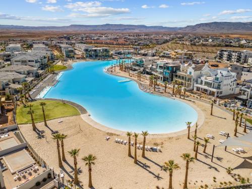 an aerial view of a resort with a pool and palm trees at Sun, Sand, and Smiles #100 condo in St. George
