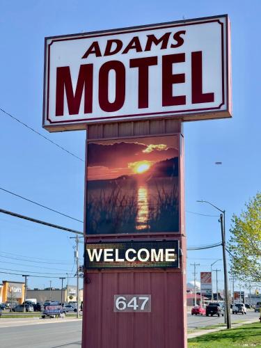 a sign for aams motel on the side of a street at Adams Motel in Sault Ste. Marie