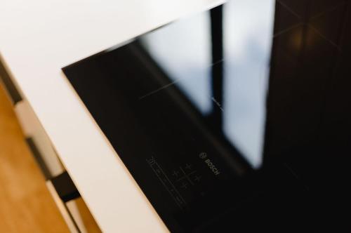 a close up of a cell phone sitting on a table at Luxe 3BR, 2Bath Townhouse w Private Garage in CBD in Wellington