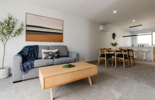 a living room with a couch and a table at Luxe 3BR, 2Bath Townhouse w Private Garage in CBD in Wellington