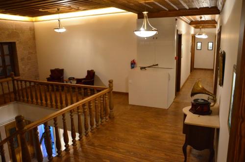 a hallway with a staircase and a refrigerator in a room at Orchis Hotel in Ayvalık