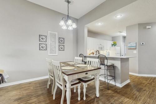 a kitchen and dining room with a table and chairs at Cypress Point at Craft Farms #304B in Gulf Shores