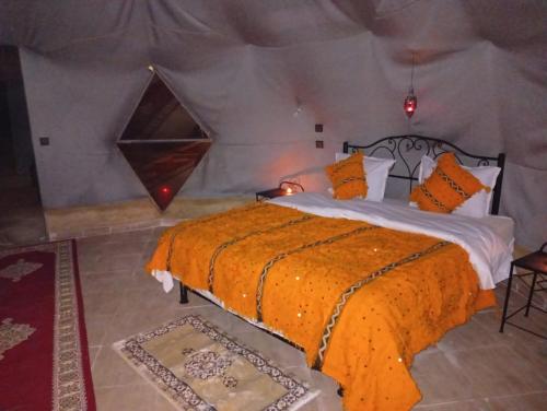 a bedroom with a bed in a tent at RestCamp ErgChebbi in Merzouga