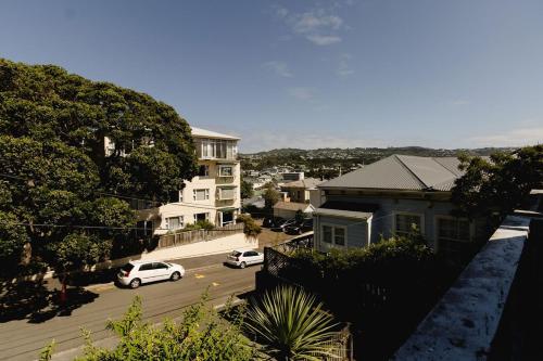 a view of a street with cars parked on the road at Comfortable 2BR Home w Free Parking, Easy Walk to City in Wellington