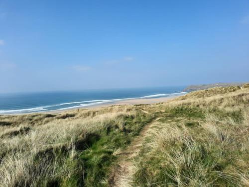 a path through the sand dunes at the beach at Ocean Breeze-Haven Perran Sands Holiday Park in Perranporth