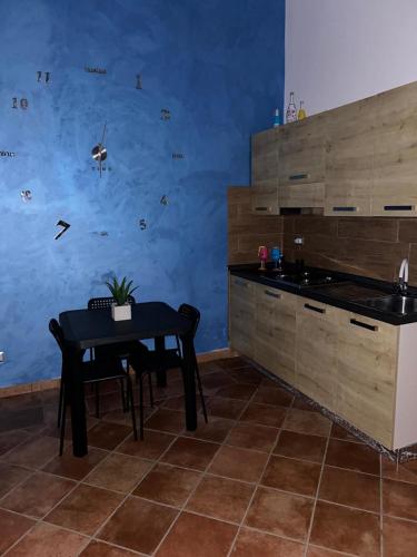 a kitchen with a black table and a sink at Il Rustico in Pozzillo
