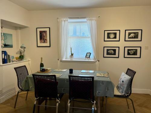 a dining room with a table and chairs and a window at Bank House Pittenweem self catering accommodation in Pittenweem