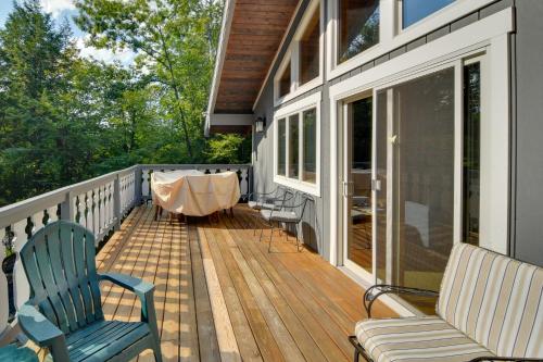 a porch with chairs and a table on a house at Beautiful Chalet about 5 Miles to Attitash Mountain in Glen