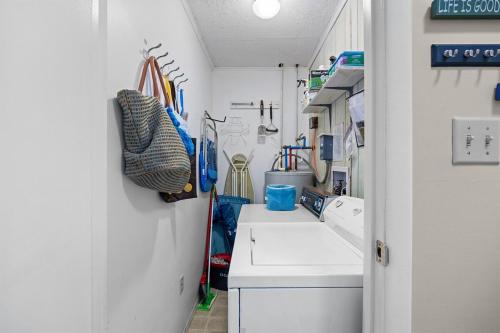a bathroom with a sink and a washing machine at Ocean View Windy Village Unit 2B 2 bedroom 2 bath Sleep 6 Pool in North Myrtle Beach