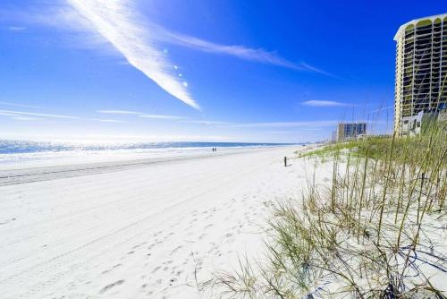 a beach with footprints in the sand and the ocean at Ocean View Windy Village Unit 2B 2 bedroom 2 bath Sleep 6 Pool in North Myrtle Beach