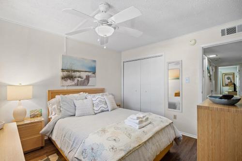 a bedroom with a bed and a ceiling fan at Ocean View Windy Village Unit 2B 2 bedroom 2 bath Sleep 6 Pool in North Myrtle Beach