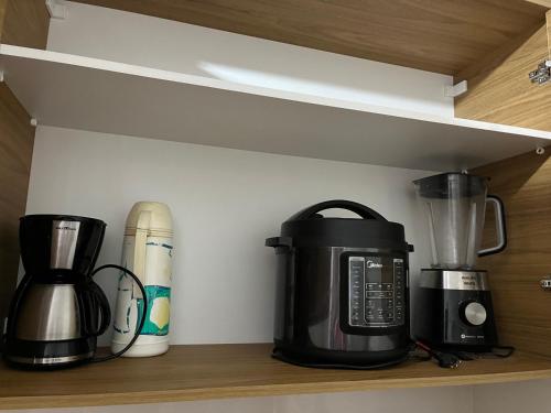 a coffee maker and a blender on a shelf at Apartamento Boa Vista in Garanhuns