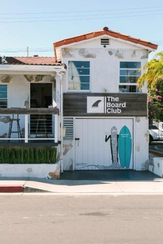 a building with a garage with a surfboard on it at Hotel Solarena in Newport Beach