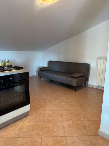 a living room with a couch and a stove at CasaMì Experience Nuvola in Acquavella