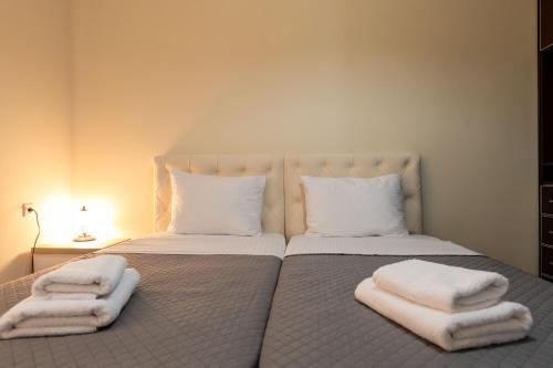 a bedroom with two beds with towels on them at Hotel Milo Ksamil in Ksamil