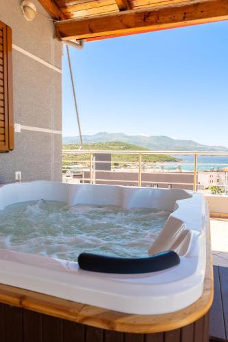 a jacuzzi tub with a view of the ocean at Hotel Milo Ksamil in Ksamil