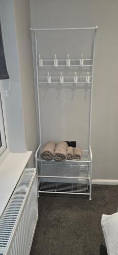 a small closet with shelves in a room at Alross Guest House in London